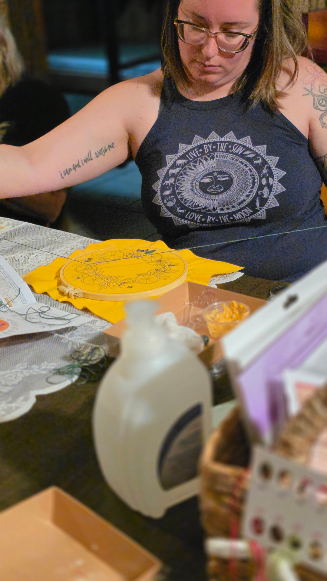 Close-up of a yellow embroidery hoop being stitched