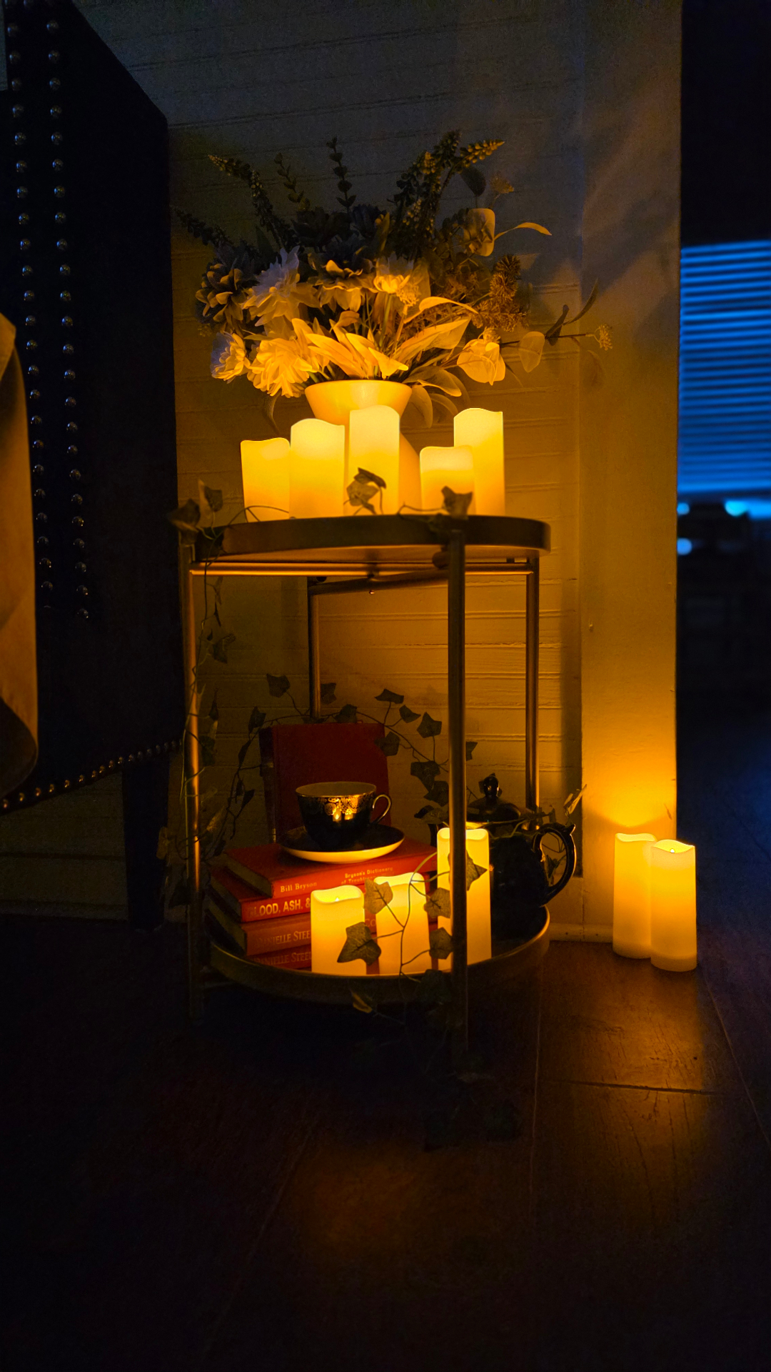 Portrait view of tea cart with candles and books