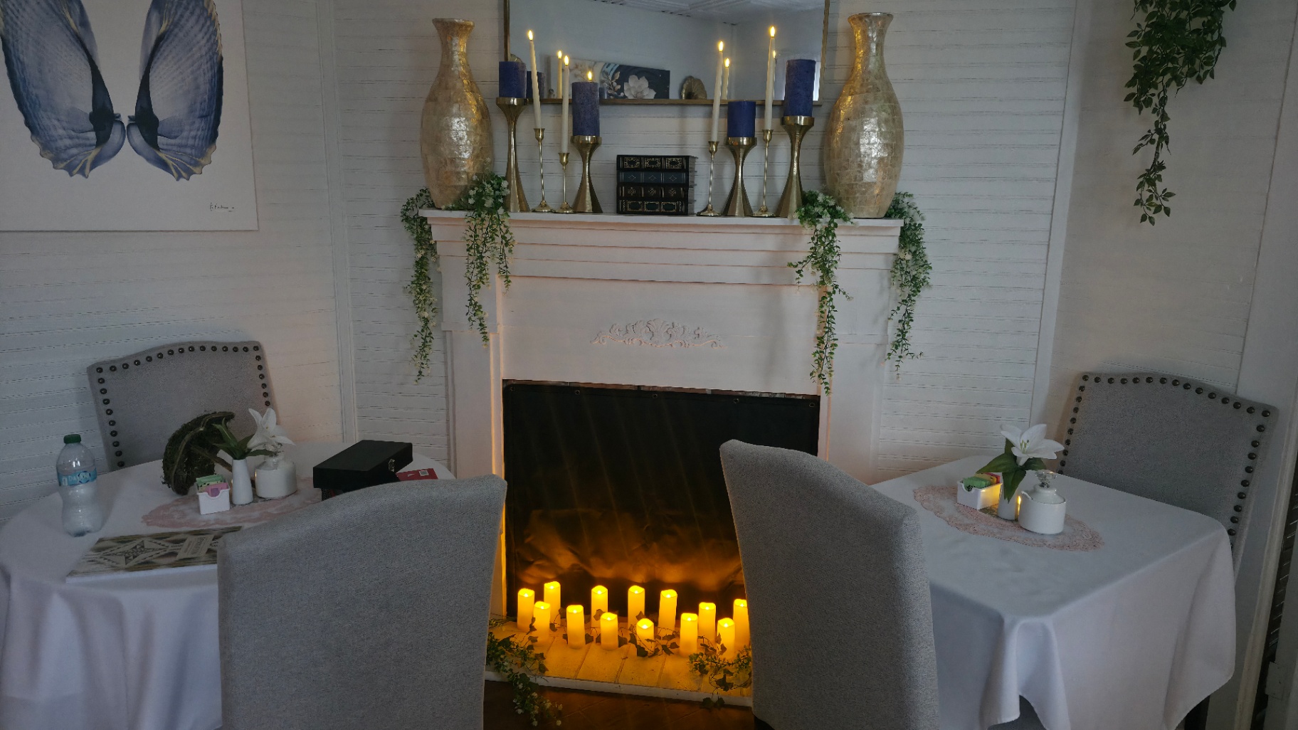 Candlelit fireplace with tables set for crafting