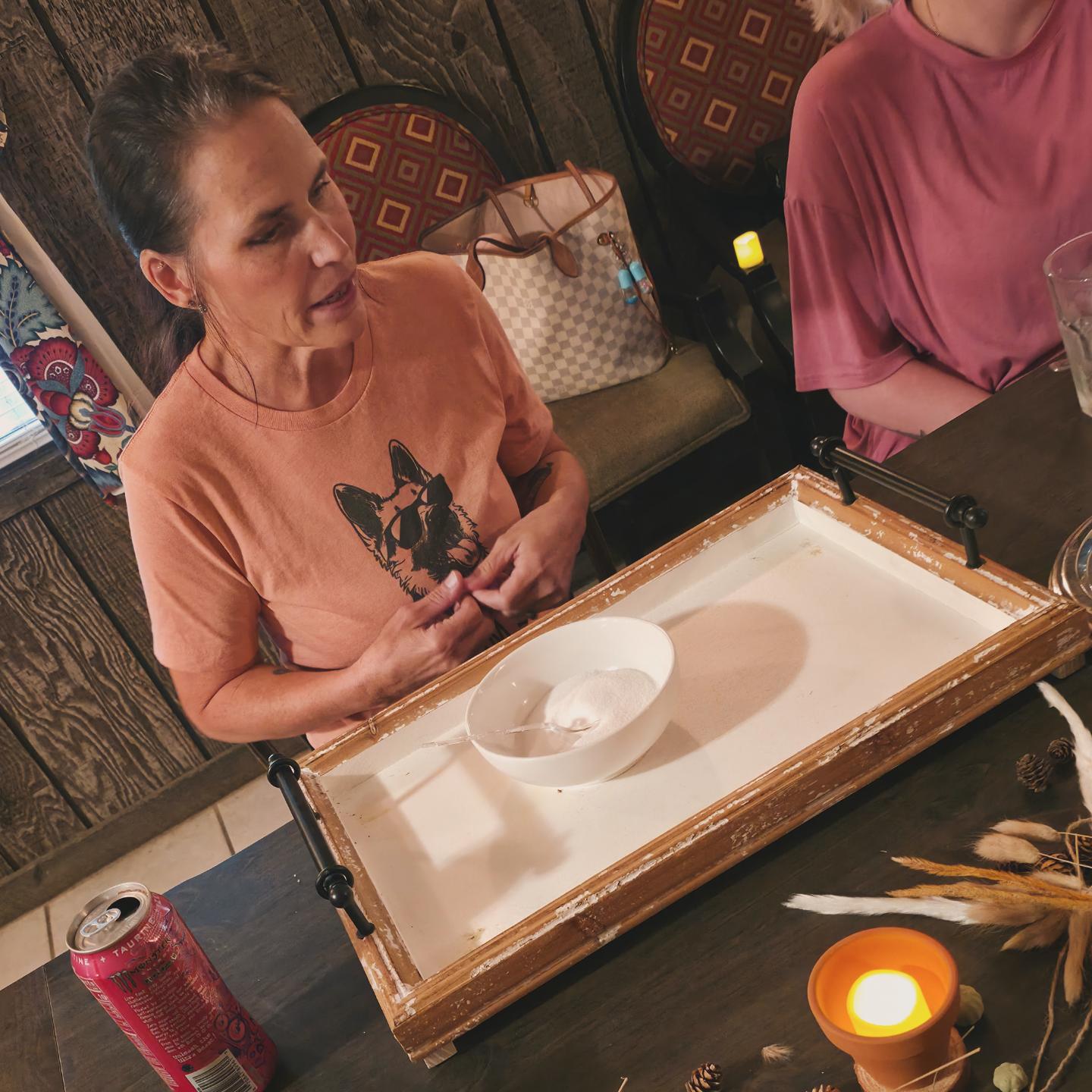 Guest working on her scrub tray at the workshop table